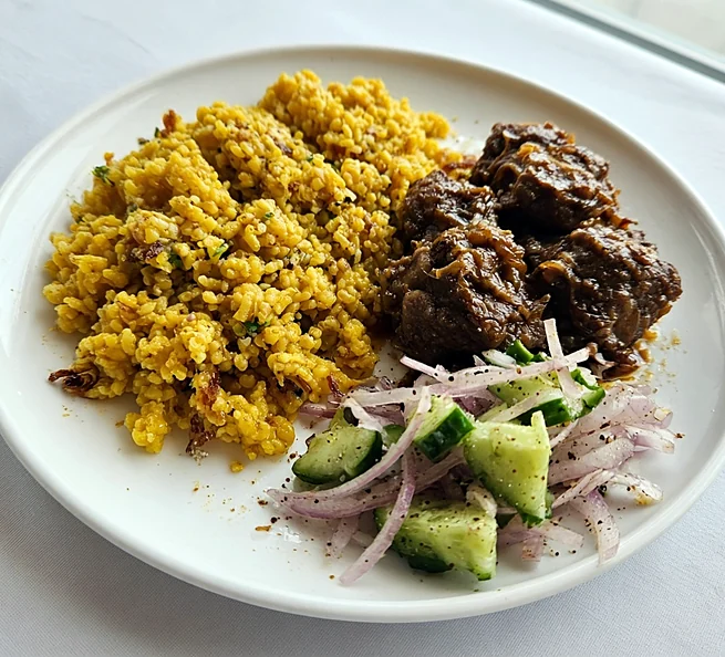 Bhuna khichuri with beef curry and cucumber-onion salad