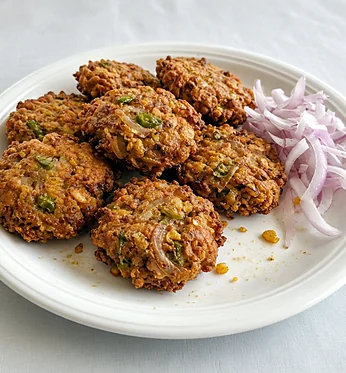 Piyaju lentil fritters with sliced raw onion